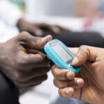 medical expert using glucometer for sugar level measurement